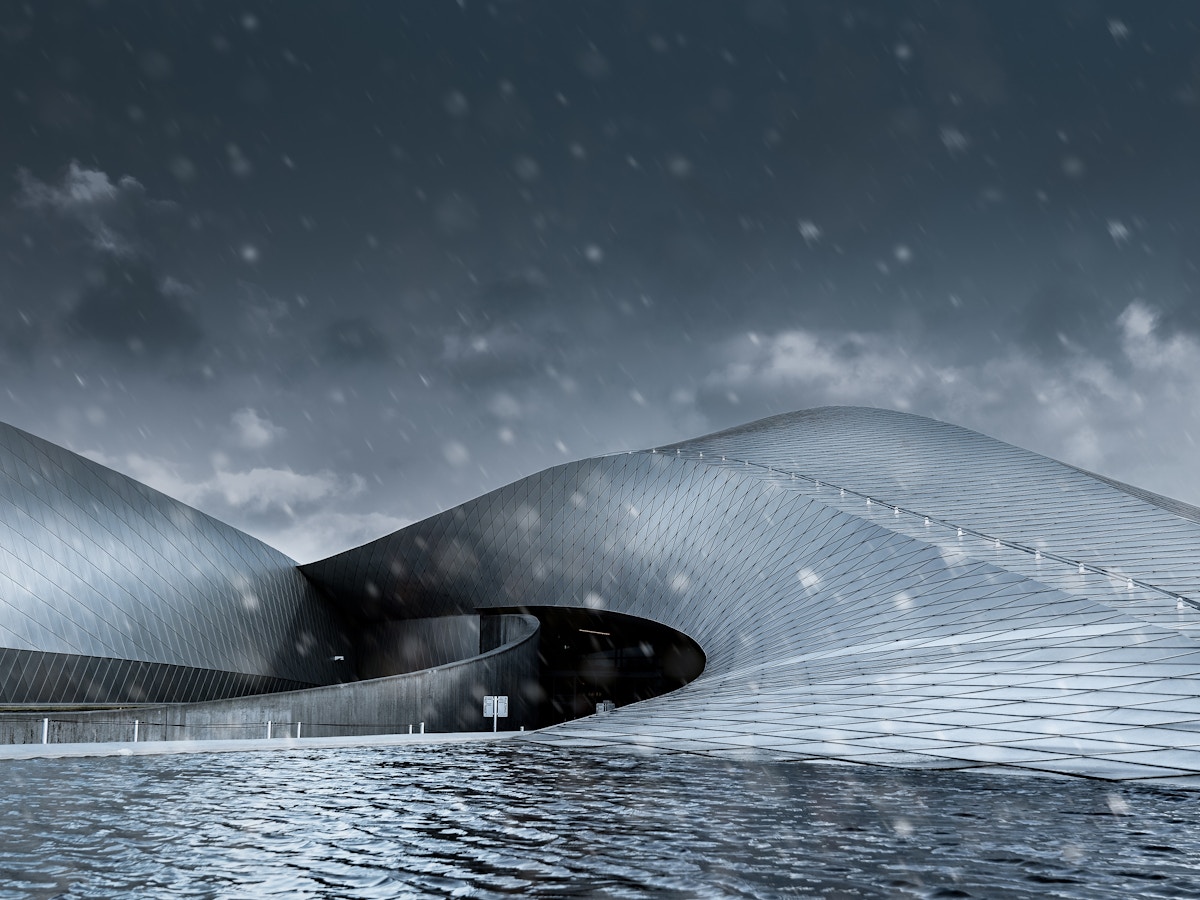 A large building in the rain. There is wavy water in the foreground