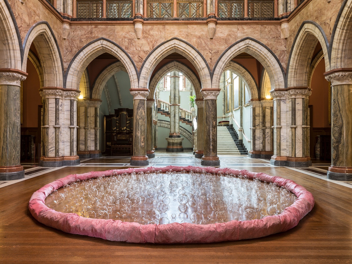 A large pink circle with glass balls in the middle.