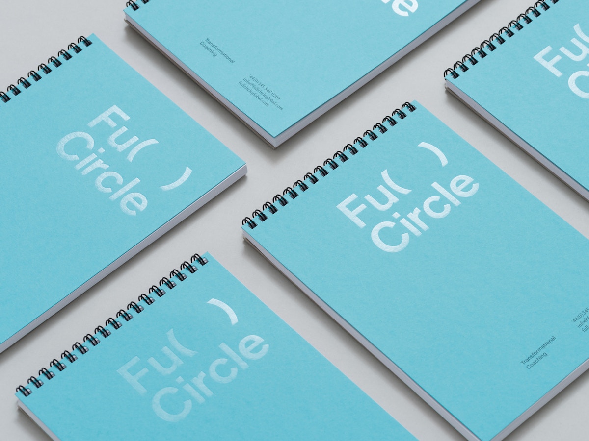 Blue wire bound notebooks with the Full Circle logo on them.
