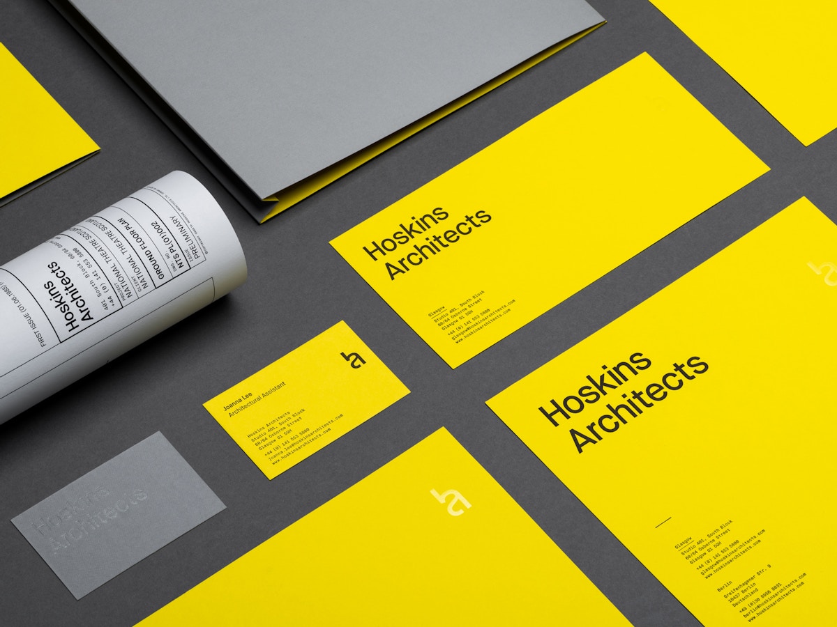 Various pieces of stationery in yellow and grey.