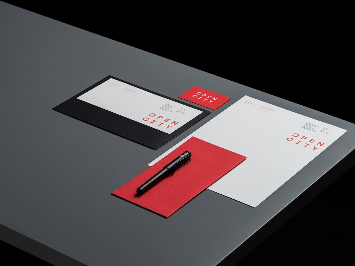 Stationery for Open City. There is type set in red that reads "Open City" on it.